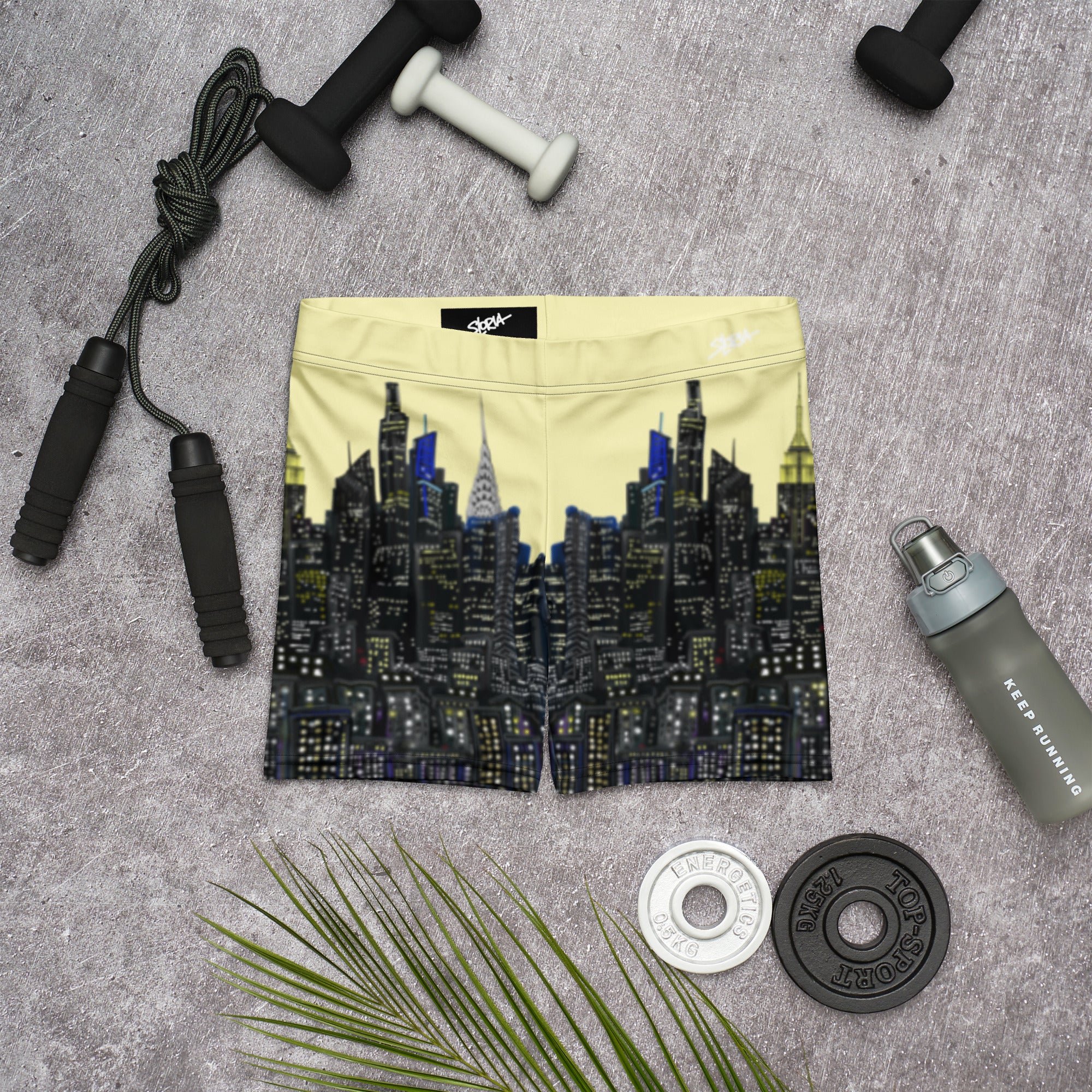 NY Cityscape design shorts with fitness equipment on a gray surface