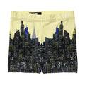Yellow shorts with a Loria NYC Art cityscape design on a white background