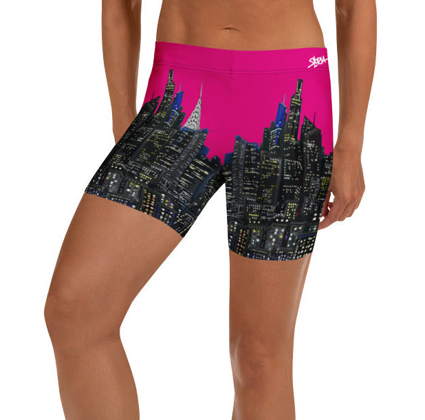Person wearing pink and black Loria NYC Art shorts on a white background