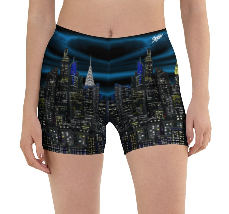 Person wearing shorts with a Loria NYC Art cityscape design on a white background