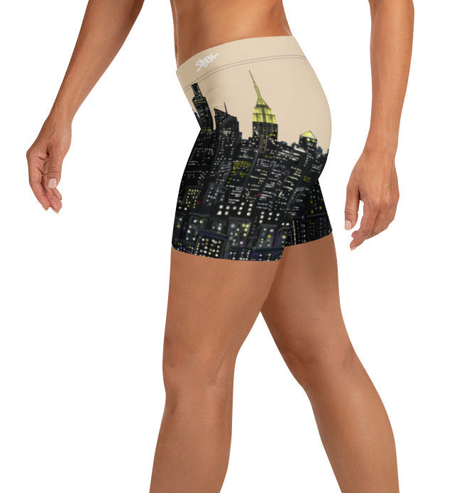 Person wearing shorts with a cityscape Loria NYC Art design on a white background