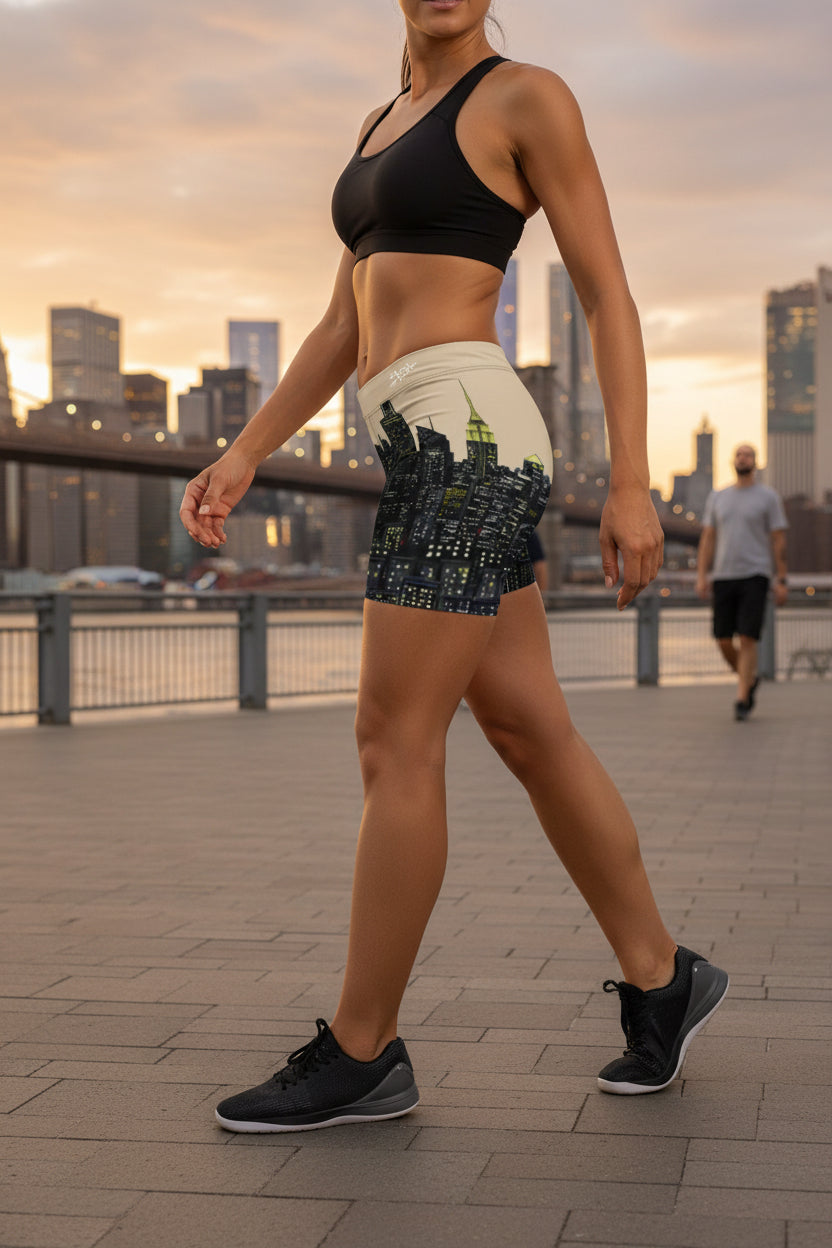 Person wearing shorts with a Loria NYC Art cityscape design on a white background
