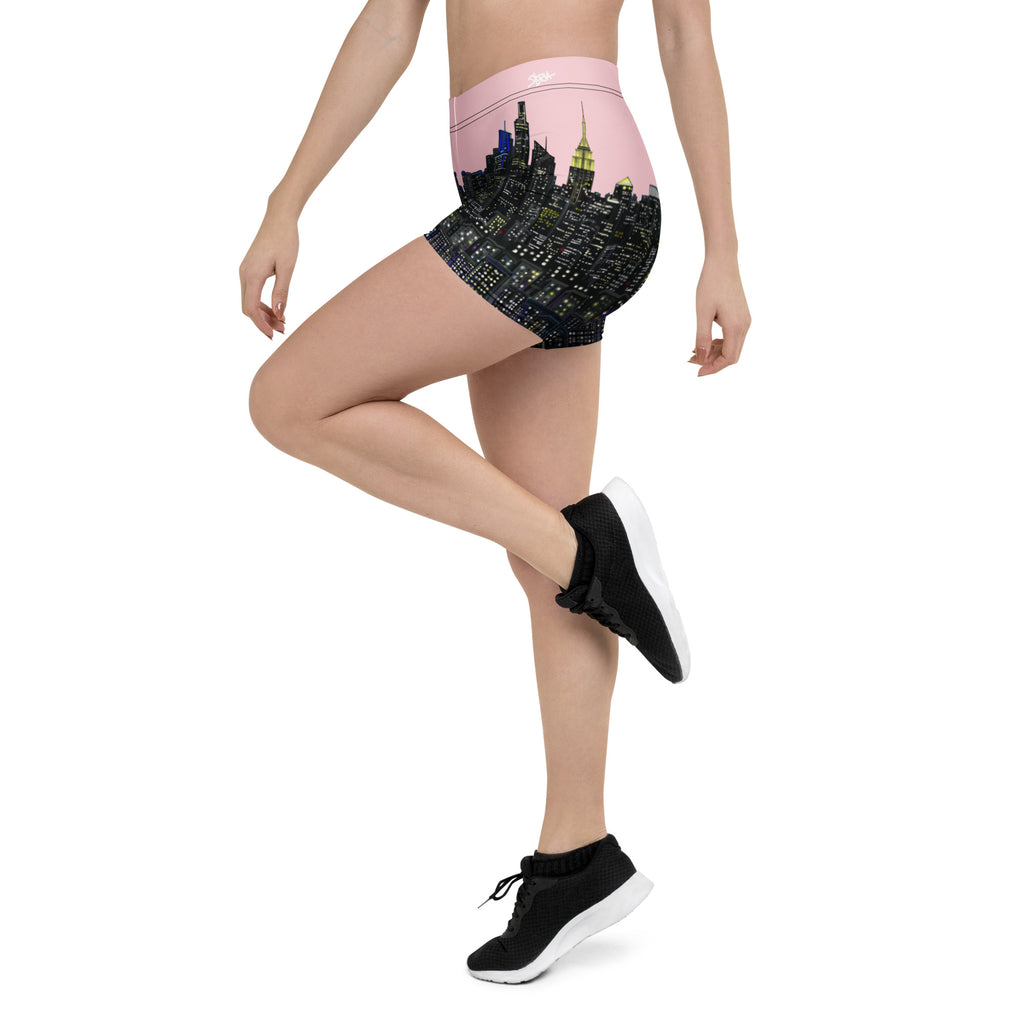 Person wearing black and pink Loria NYC Art shorts on a white background