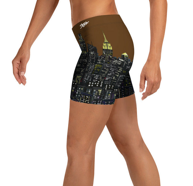 Person wearing shorts with a cityscape Loria NYC Art design on a white background