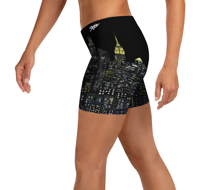 Person wearing black shorts with a cityscape Loria NYC Art design on a white background