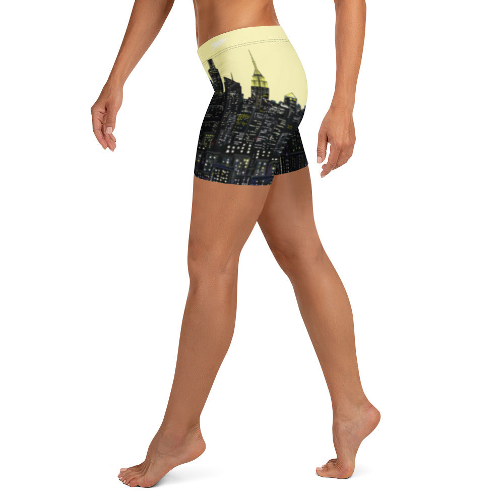 Yellow Shorts with a Loria NYC Art cityscape design on a white background
