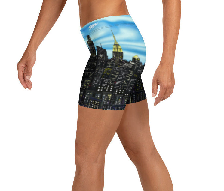 Person wearing shorts with a Loria NYC Art cityscape design on a white background