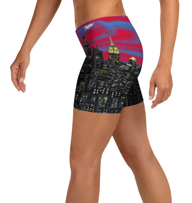 Person wearing shorts with a Loria NYC Art cityscape design on a white background