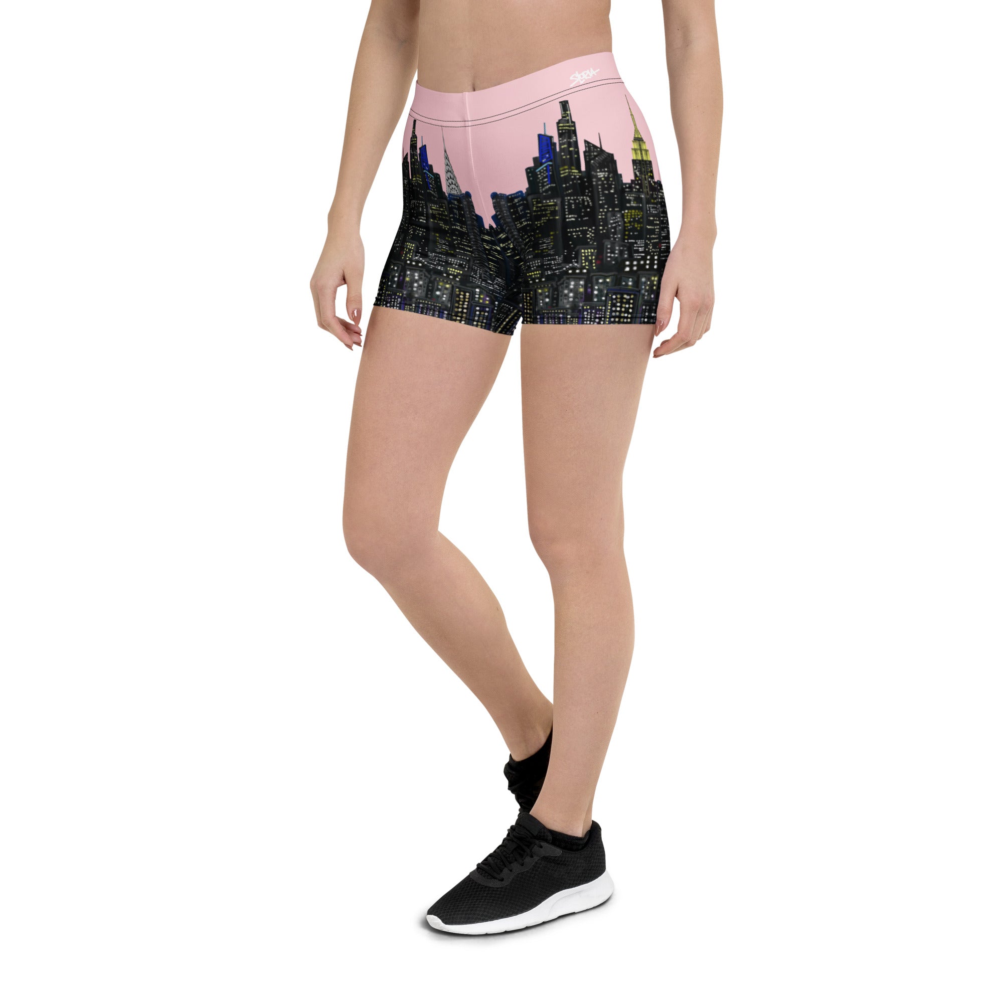 Person wearing pink shorts with cityscape Loria NYC Art design on a white background