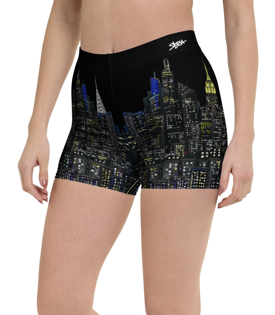 Person wearing black shorts with cityscape Loria NYC Art design on a white background