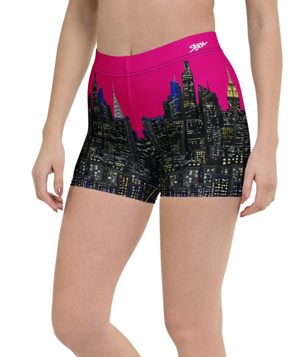 Person wearing pink shorts with a cityscape Loria NYC Art design on a white background