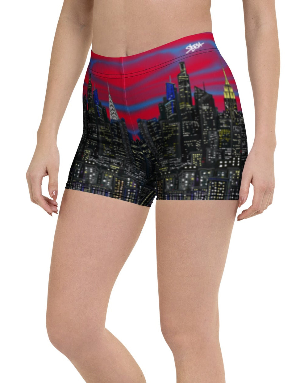 Person wearing colorful shorts with a cityscape Loria NYC Art design on a white background