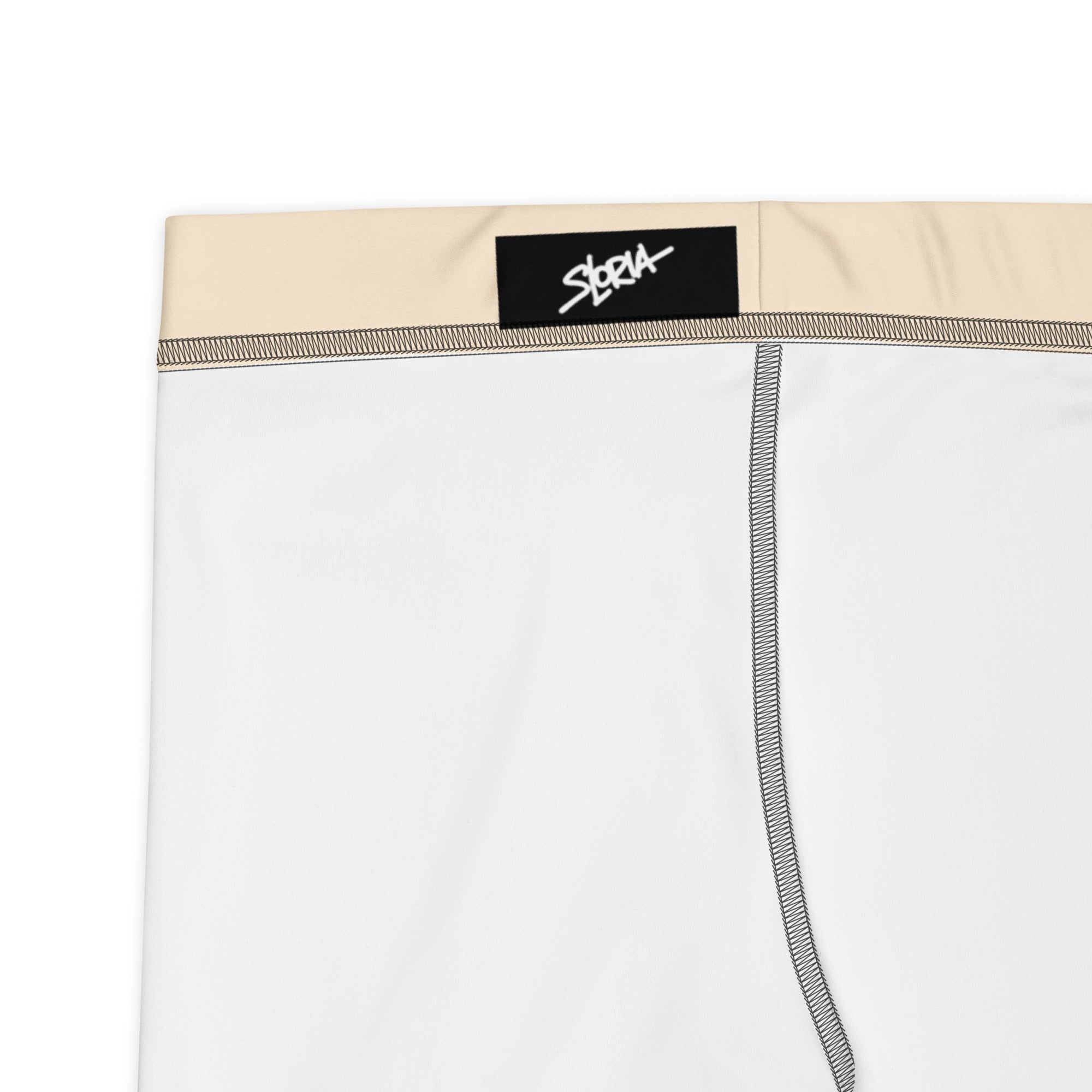 White yoga shorts with beige waistband and S. Loria brand label on a white background