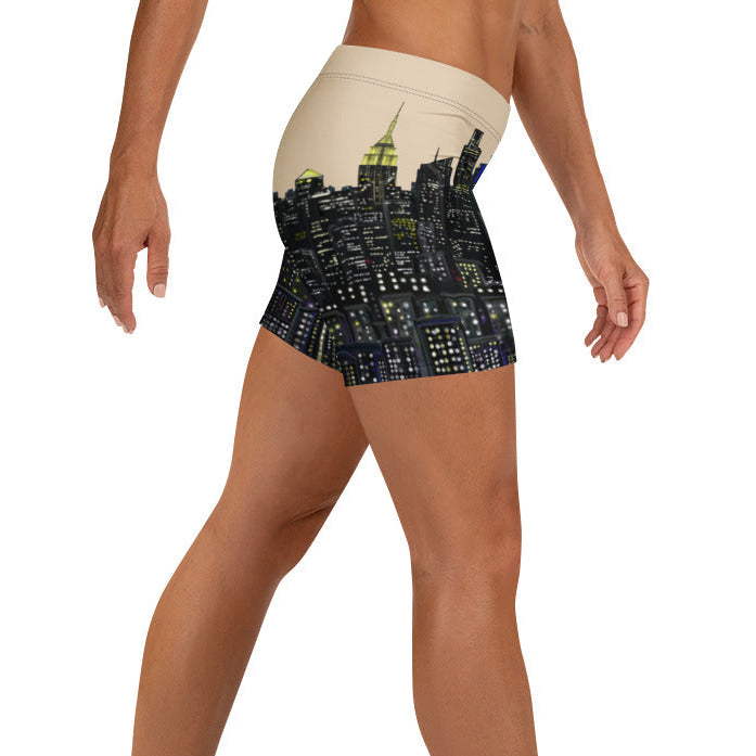 Person wearing a pair of shorts with a cityscape Loria NYC Art design on a white background