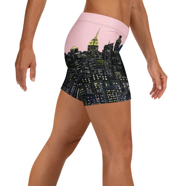 Person wearing a pair of pink shorts with a Loria NYC Art skyline on a white background