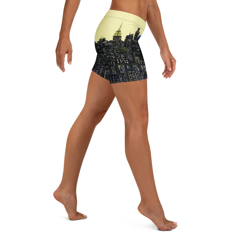 Person wearing a pair of shorts with a Loria NYC Art cityscape design on a white background