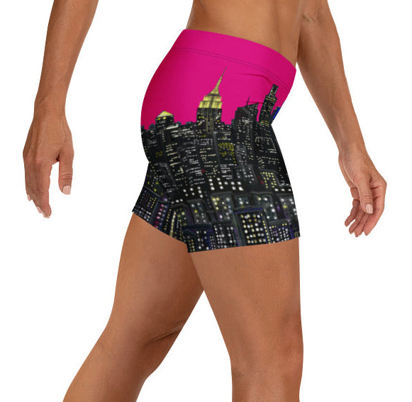 Person wearing a pair of shorts with a cityscape Loria NYC Art design on a white background