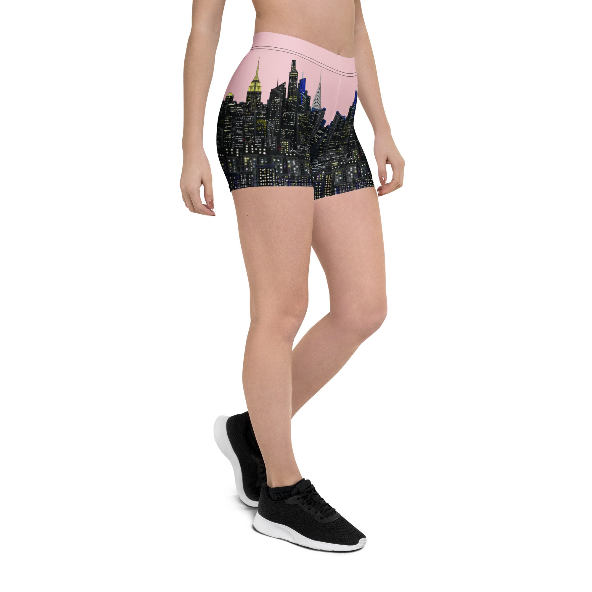 Person wearing shorts with a cityscape Loria NYC Art design on a white background