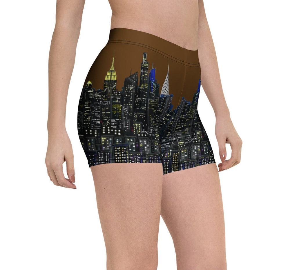 Person wearing Loria NYC Art shorts with a cityscape design on a white background