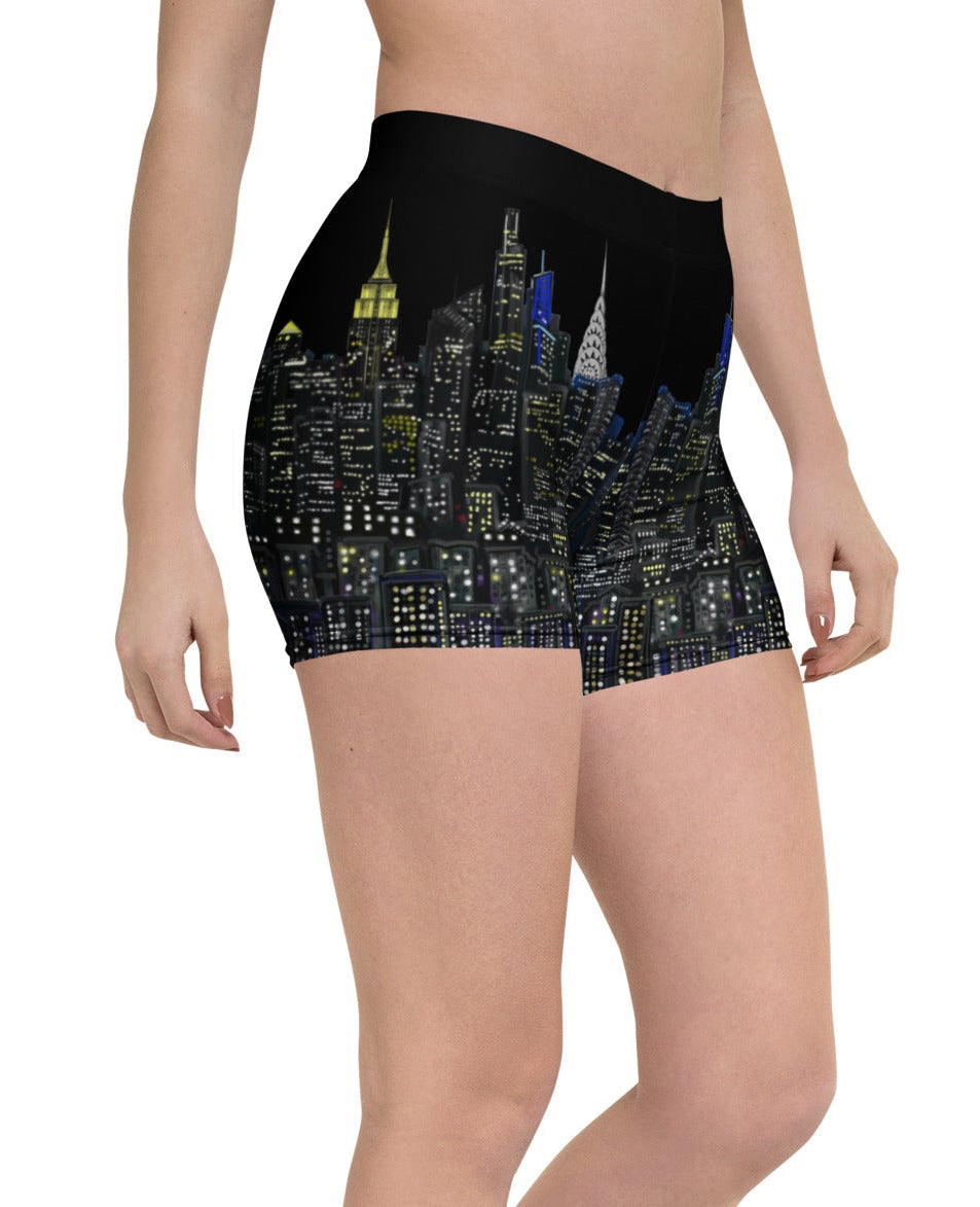 Person wearing black shorts with cityscape Loria NYC Art design on a white background