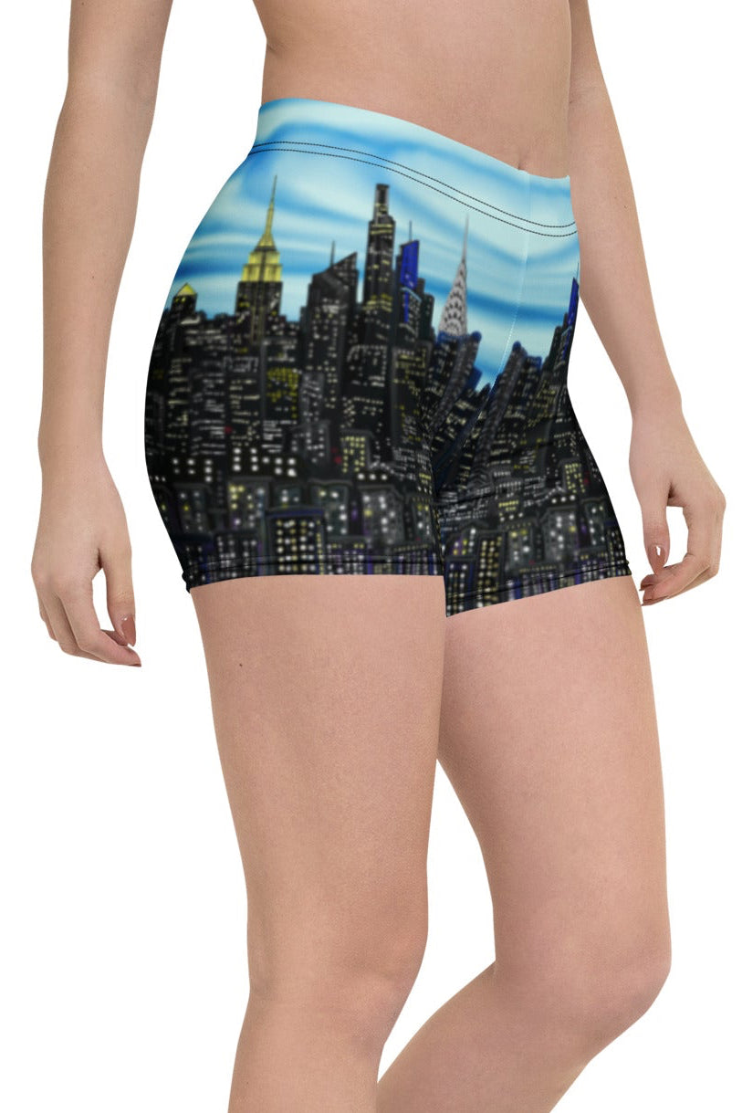 Person wearing shorts with a Loria NYC Art cityscape design on a white background
