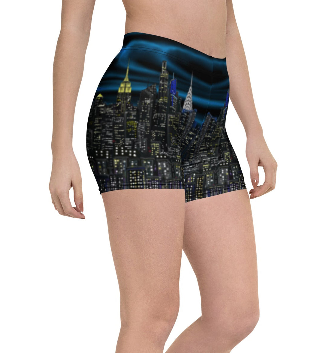 Person wearing Loria NYC Art shorts with a cityscape design on a white background