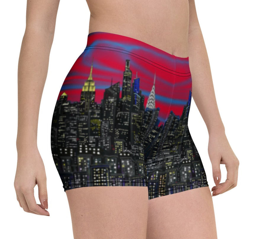 Person wearing shorts with a Loria NYC Art cityscape design on a white background