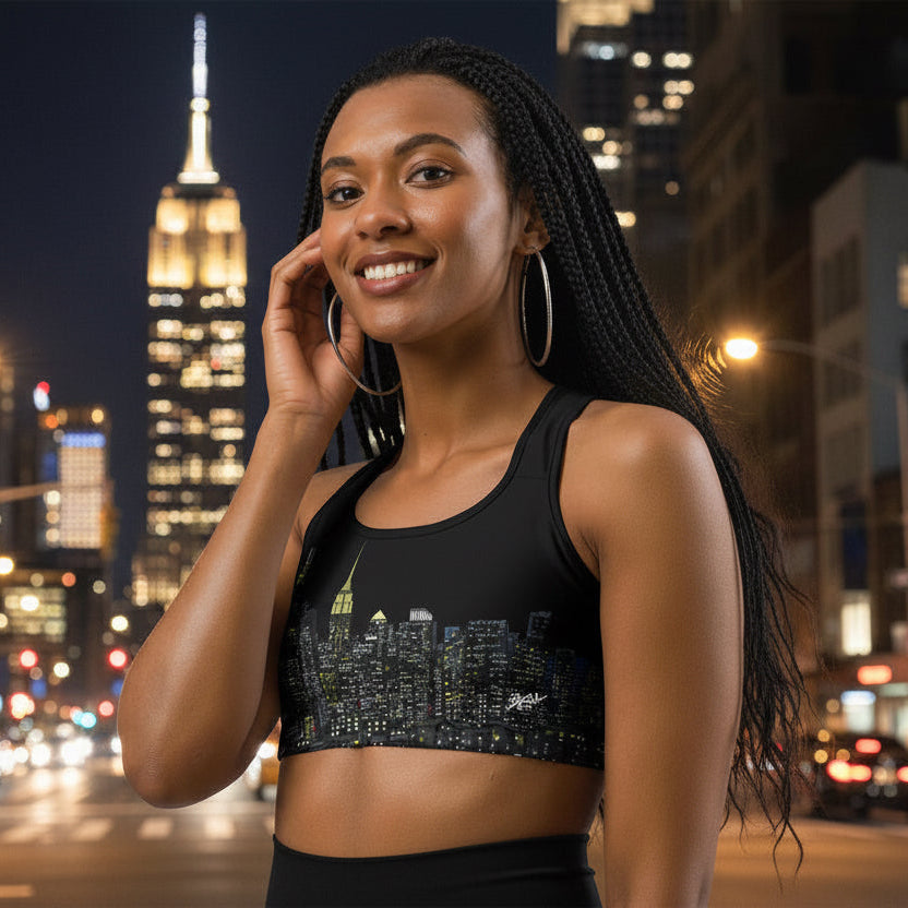 Woman wearing a black sports bra designed by Loria NYC Art with cityscape design 