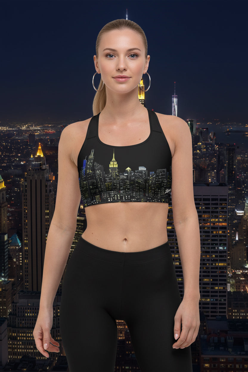 Woman wearing a black sports bra designed by Loria NYC Art with cityscape design and gray leggings on a urban background