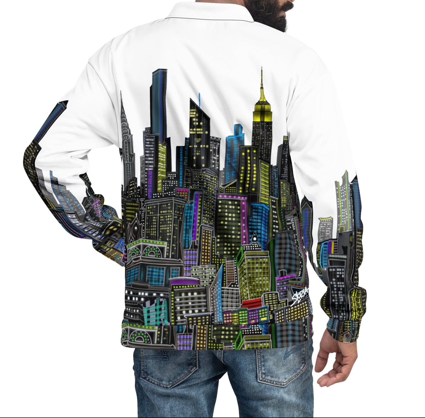 Man wearing a white shirt with a colorful cityscape designed by Loria NYC Arton the back.