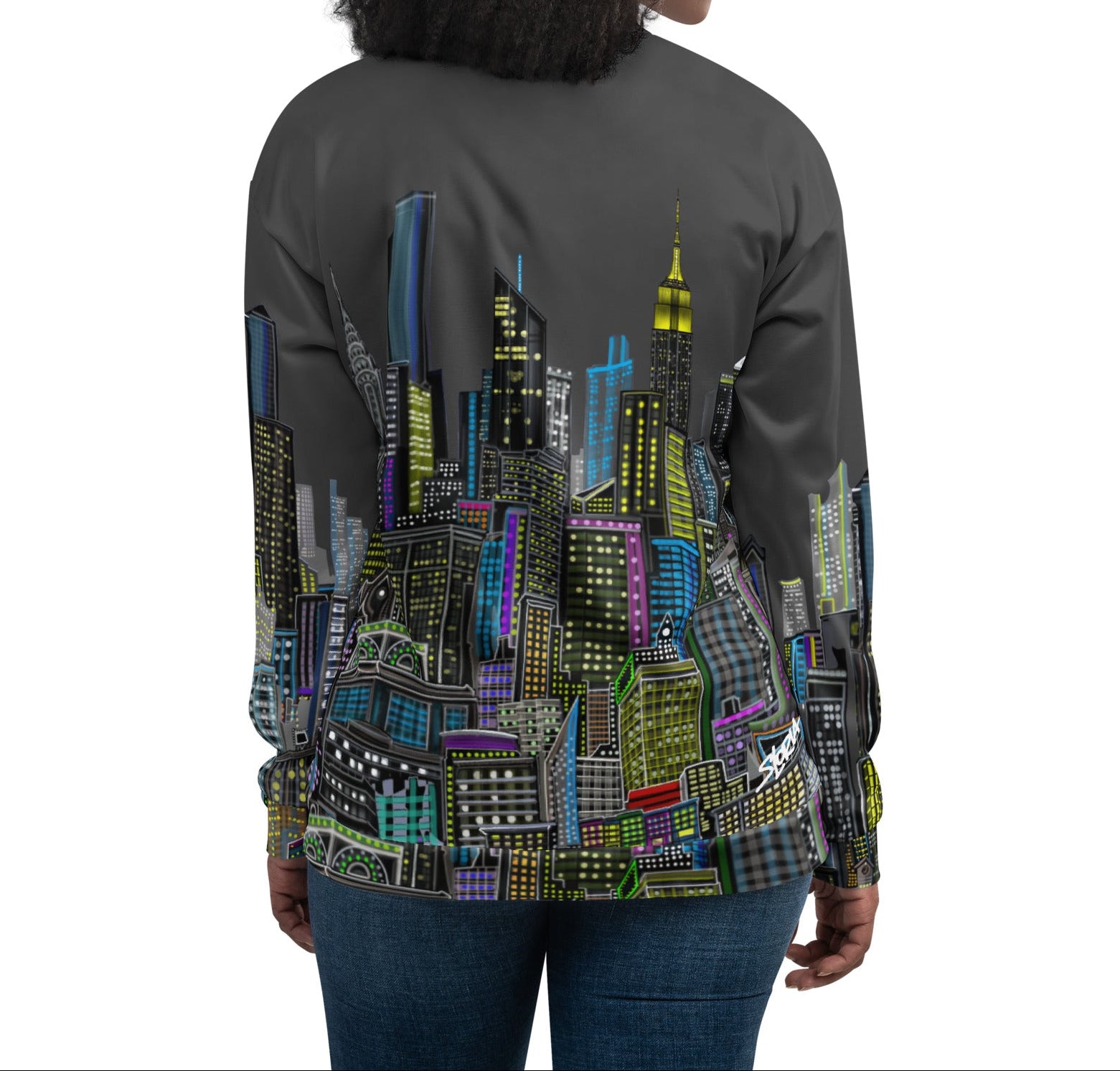 Back of Woman wearing a colorful cityscape jacket by Loria NYC Art on a white background