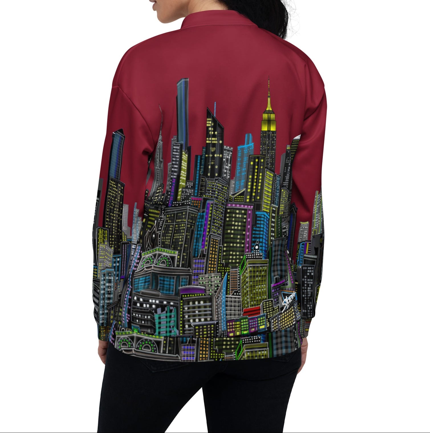Girl posing in rear view for  a maroon jacket with a colorful cityscape design by Loria NYC Art on a white background