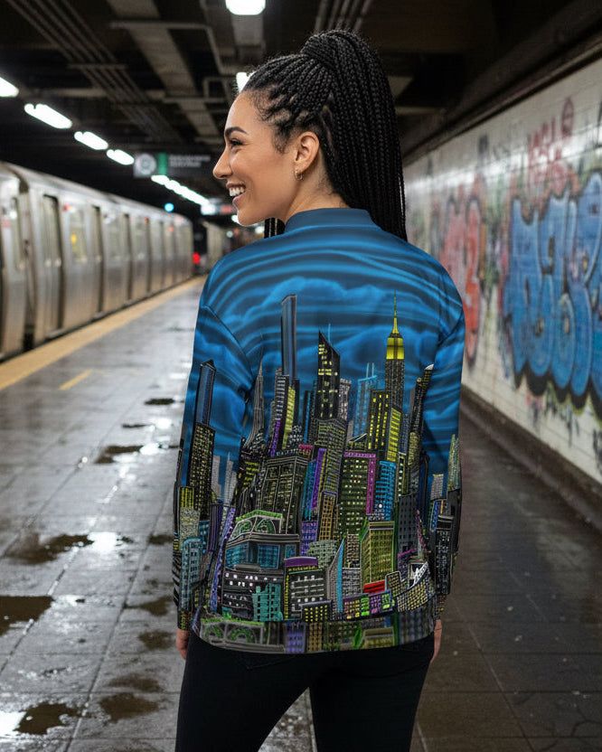 Person wearing a jacket with a cityscape designed by Loria NYC Art on a subway  background