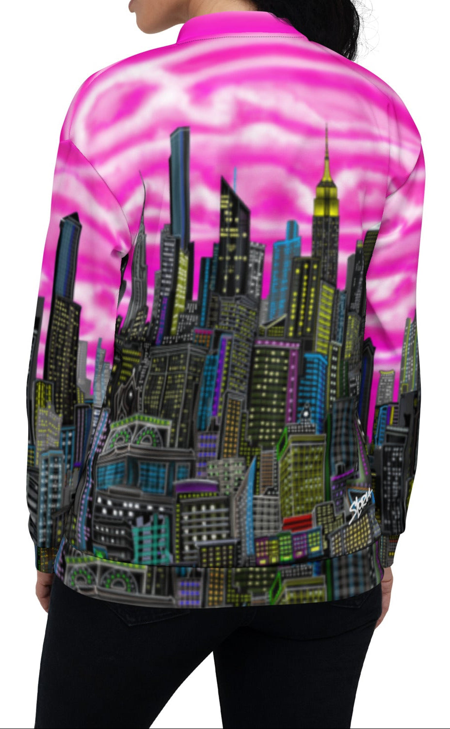 Back side of Woman wearing a colorful cityscape jacket with pink sky and tall buildings designed by Loria NYC Art