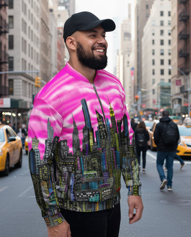 Guy wearing a colorful cityscape jacket with pink sky and tall buildings designed by Loria NYC Art
