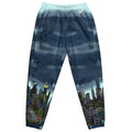 View of blue track pants with cityscape design by Loria NYC Art on a white background