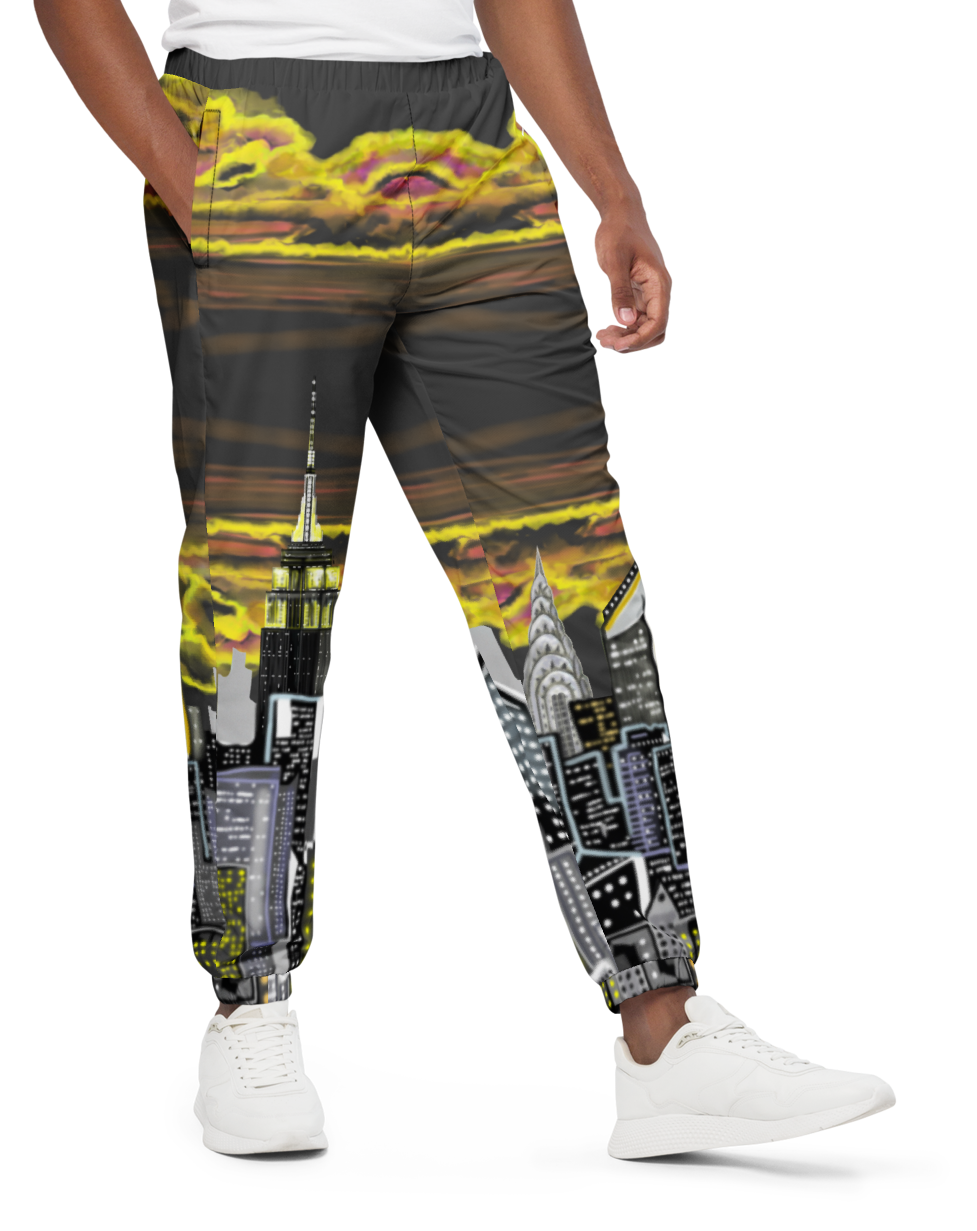 Man wearing a white t-shirt and patterned Loria NYC Art pants on a white background