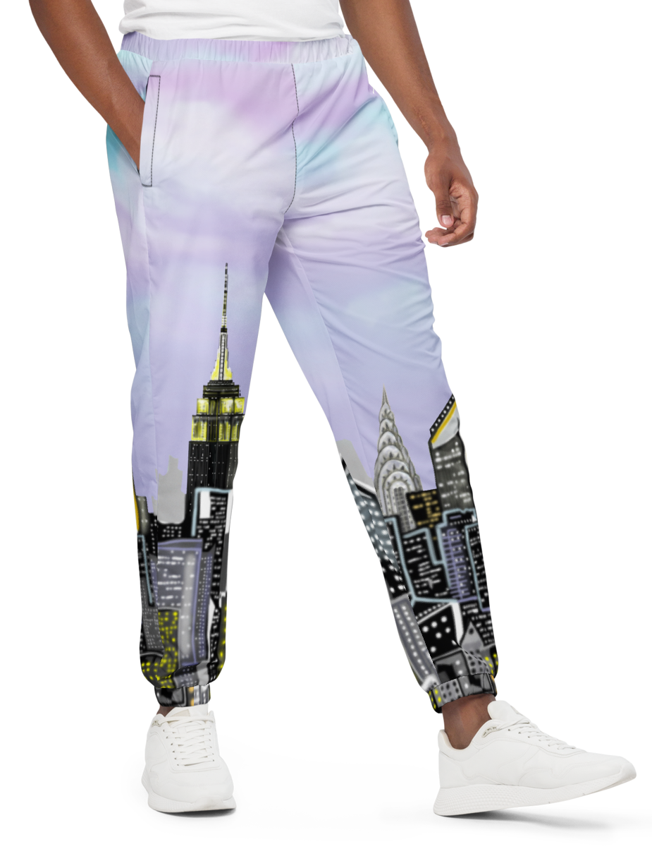Man wearing a white t-shirt and colorful pants with cityscape Loria NYC Art design on a white background