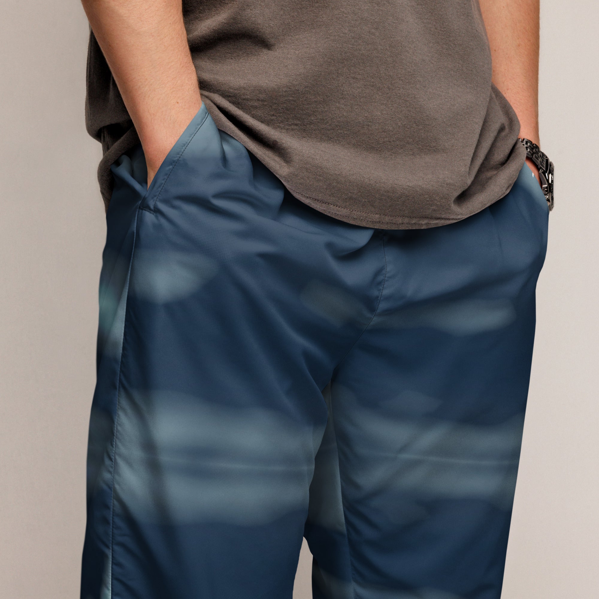 Person wearing blue pants and a brown shirt on a beige background