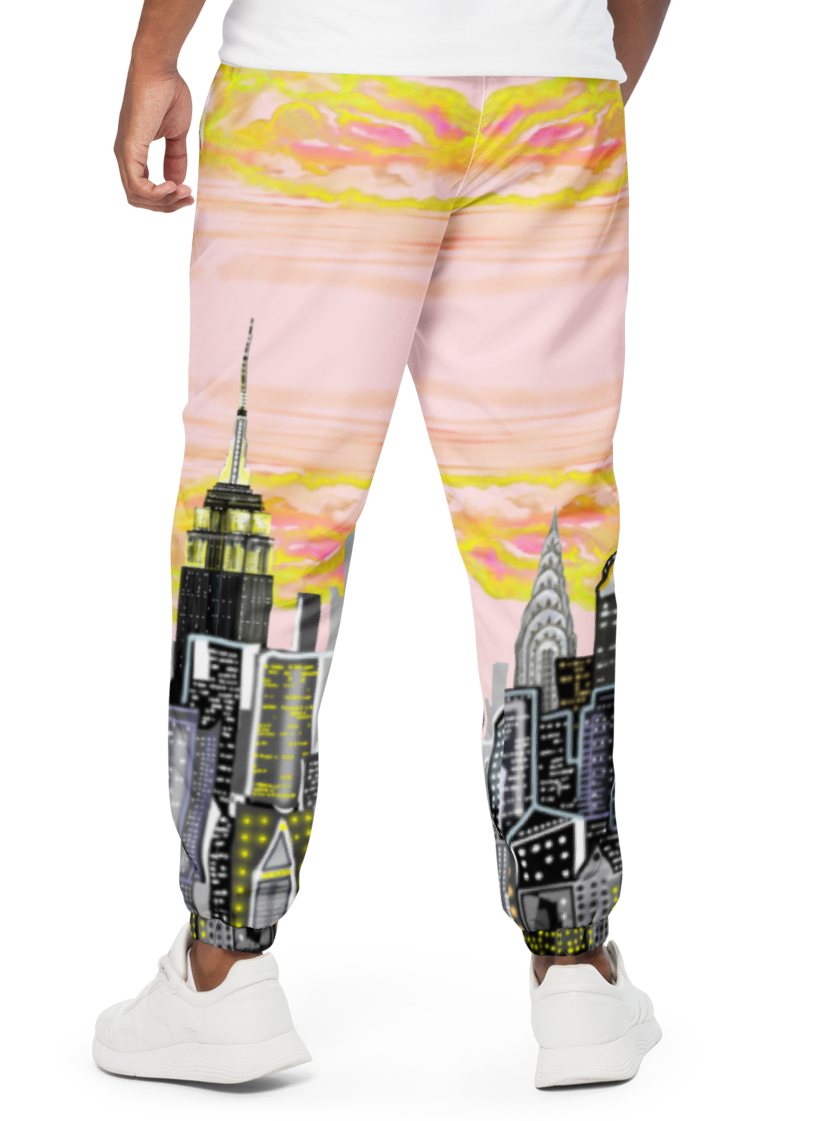 Person wearing a white t-shirt and colorful pants with cityscape Loria NYC Art design on a white background