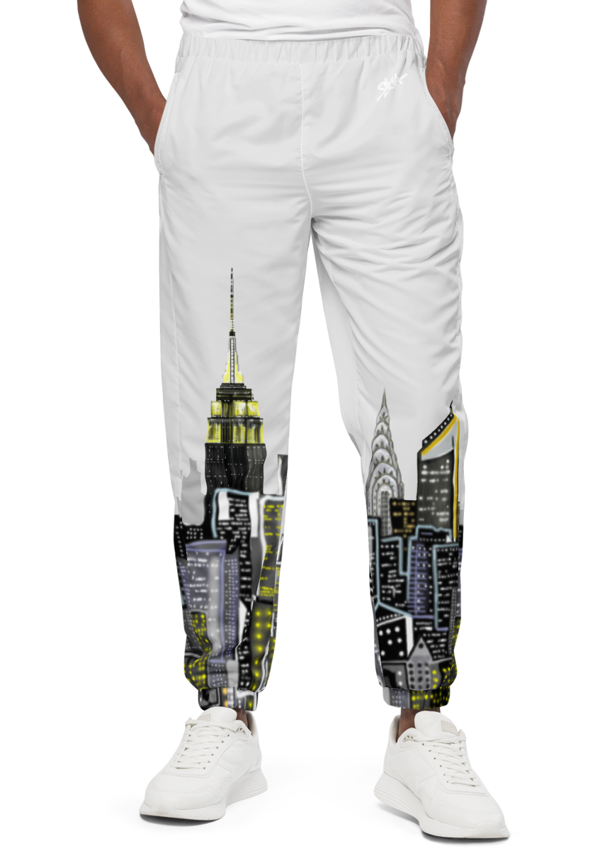 Man wearing a white t-shirt and Loria NYC Art pants with graphic designs on a white background