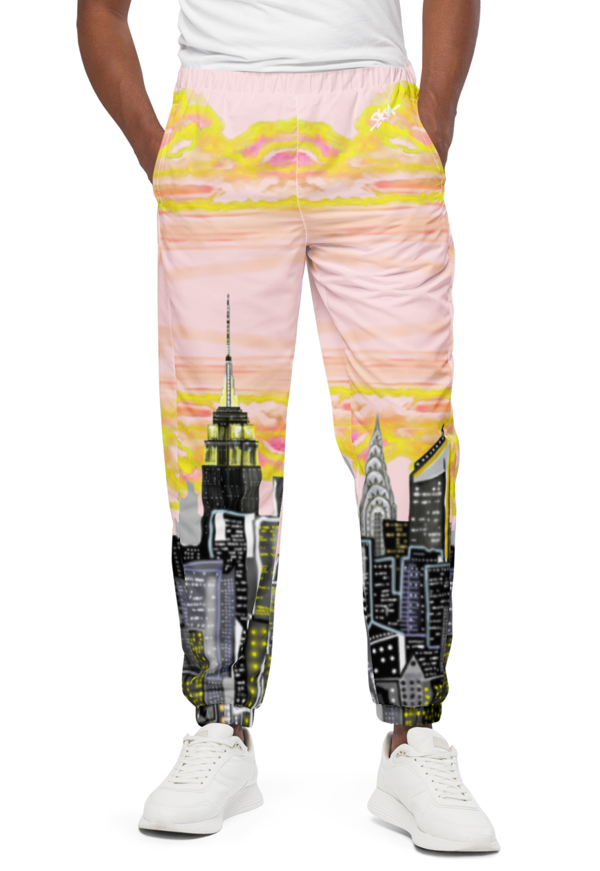 Person wearing a white t-shirt and Loria NYC Art colorful pants on a white background