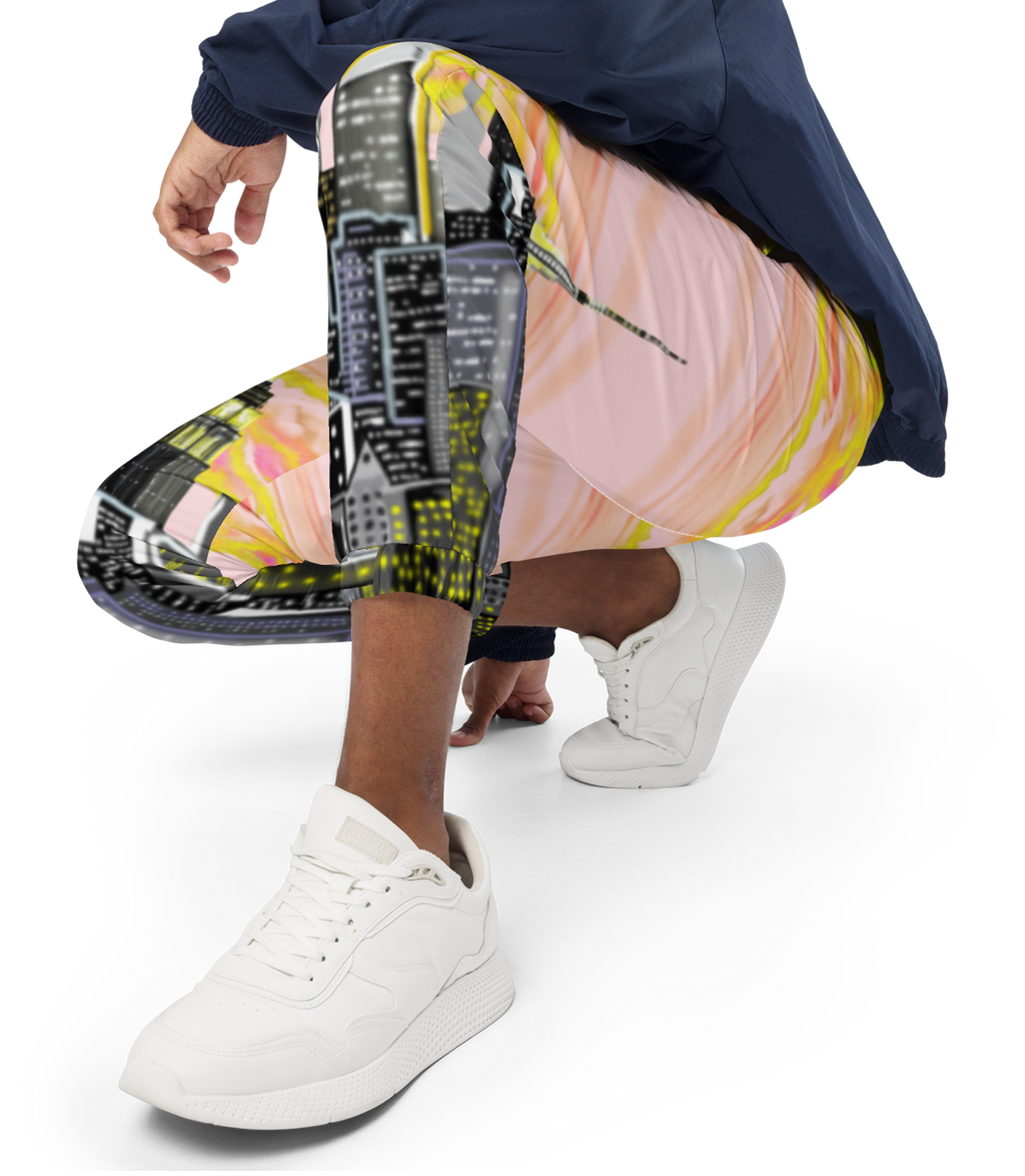 Person wearing colorful Loria NYC Art pants and a navy jacket on a white background