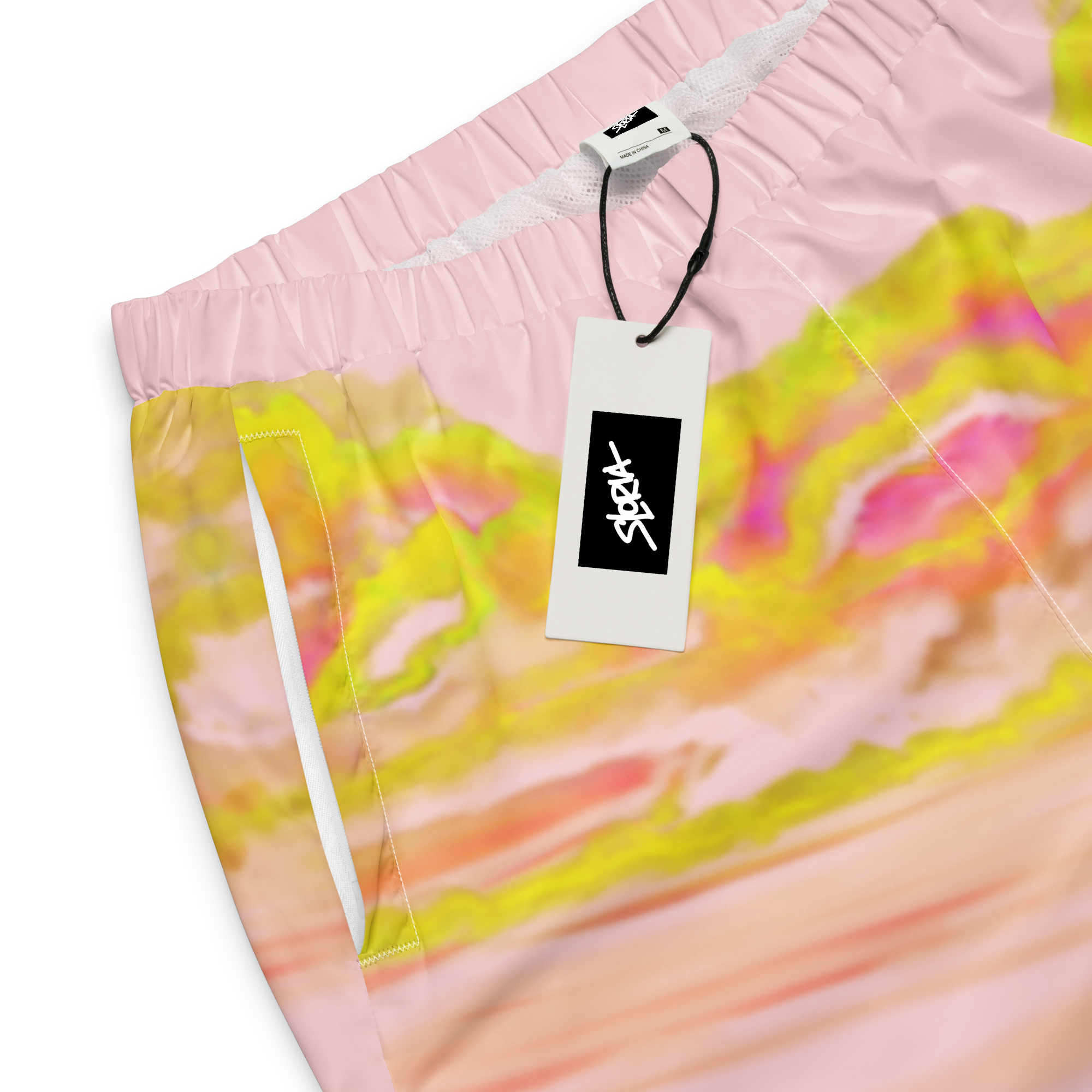 Colorful tie-dye Loria NYC Art pants with a brand tag on a white background