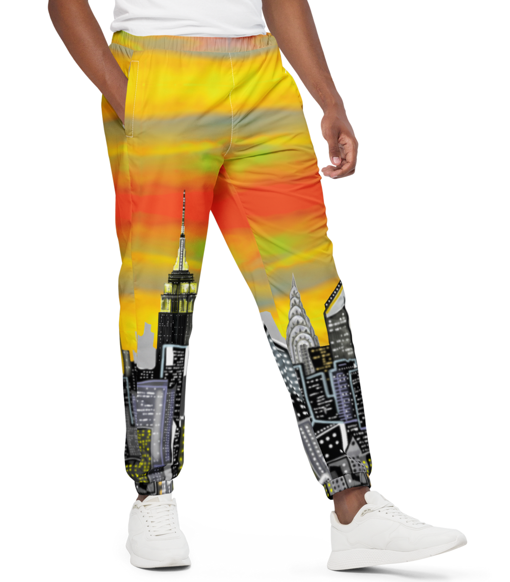 Man wearing a white t-shirt and colorful pants with cityscape Loria NYC Art design on a white background