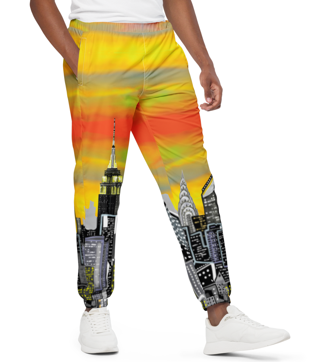 Man wearing a white t-shirt and colorful pants with cityscape Loria NYC Art design on a white background