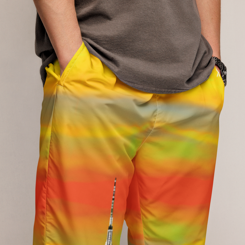 Person wearing a colorful Loria NYC Art pants with a neutral background