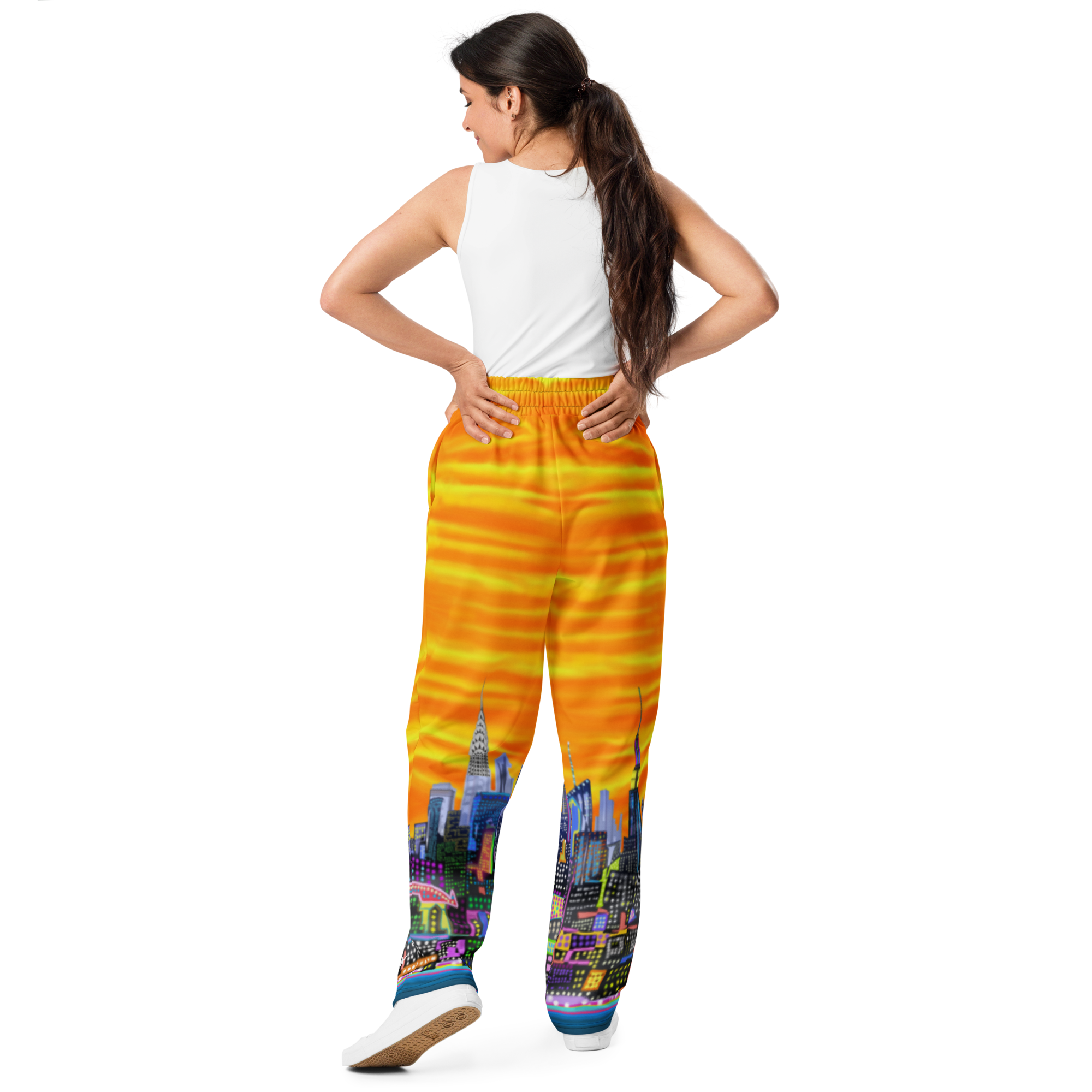 Woman wearing colorful pants with a Loria NYC Art cityscape design on a white background