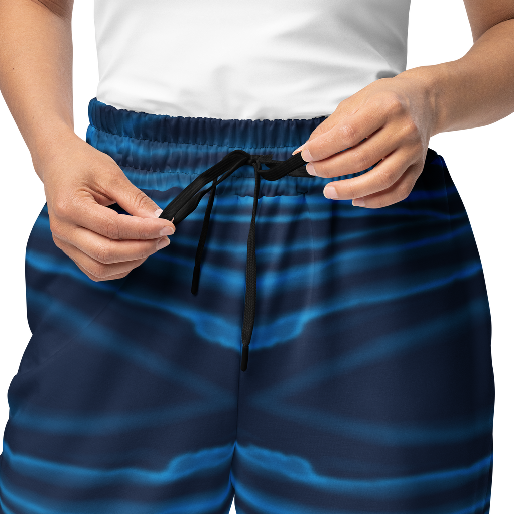 Person wearing blue Loria NYC Art pants with a white background