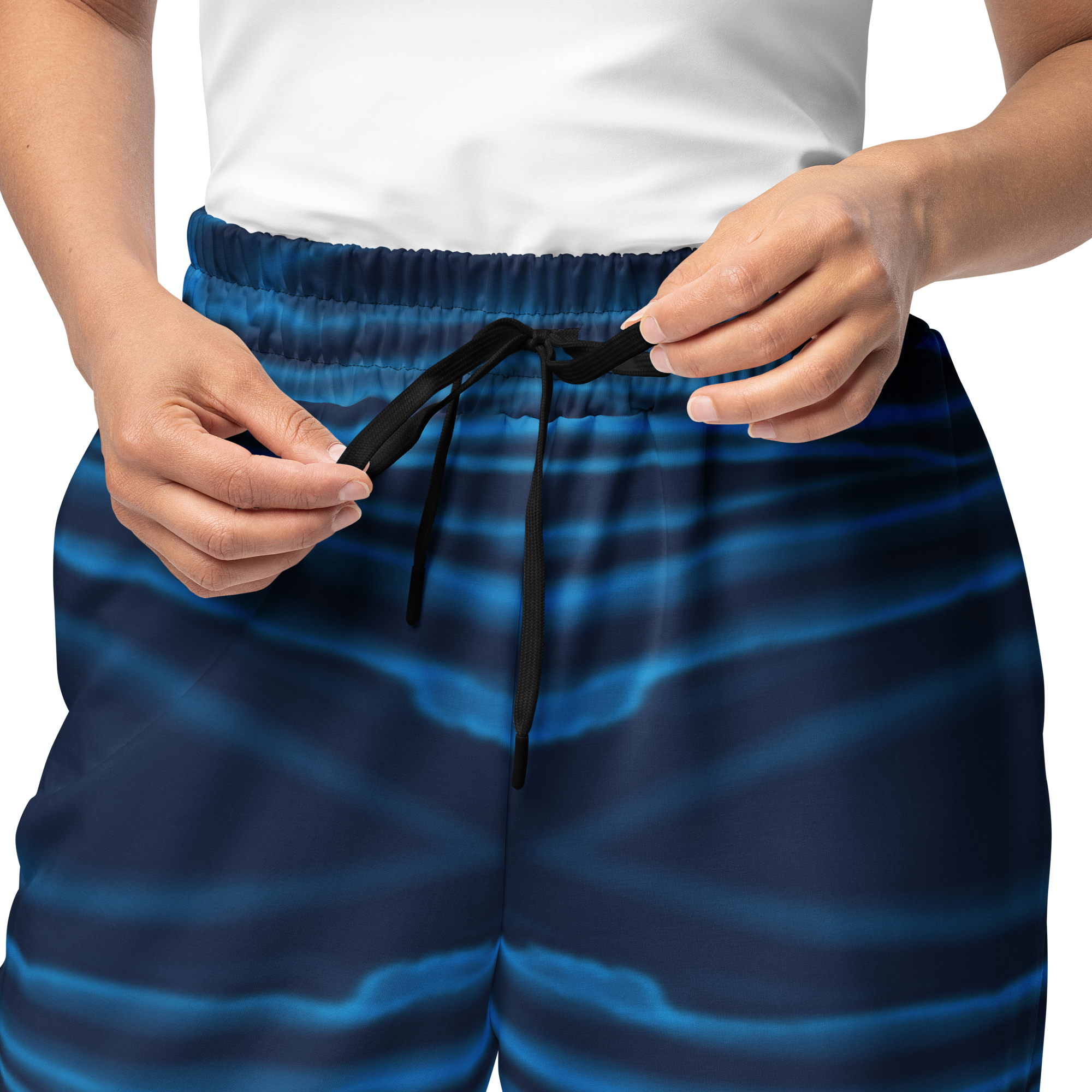 Person wearing blue Loria NYC Art pants with a white background